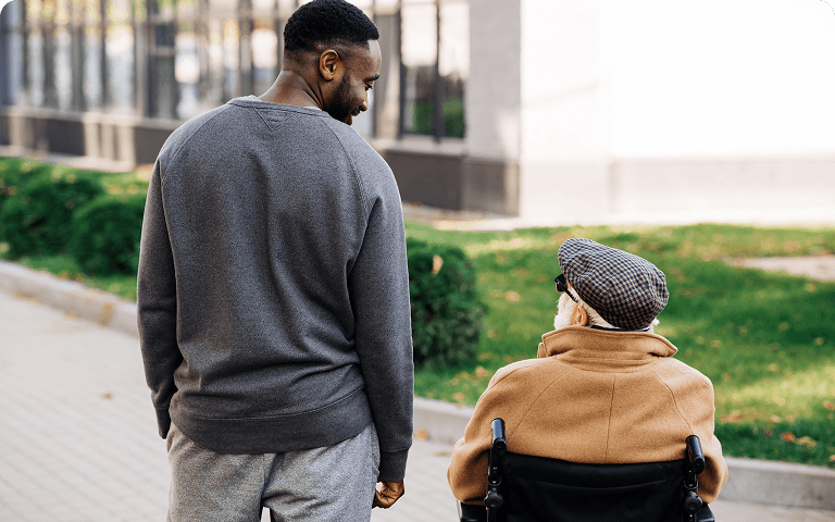 Care worker walking outdoors with a client