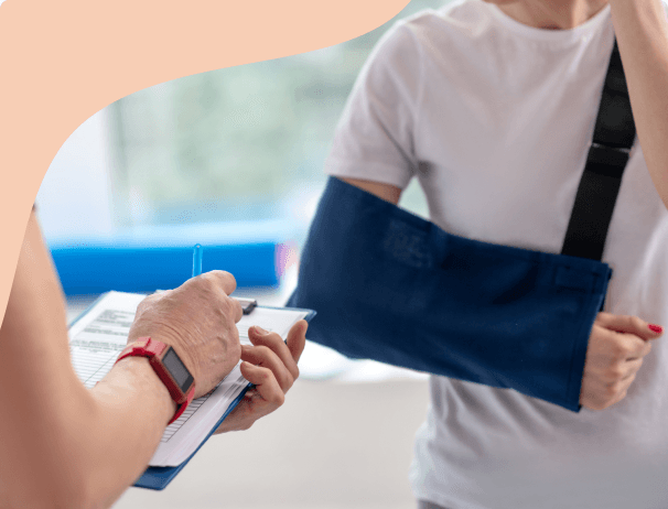 Person resting an injured leg on a pillow with crutches nearby